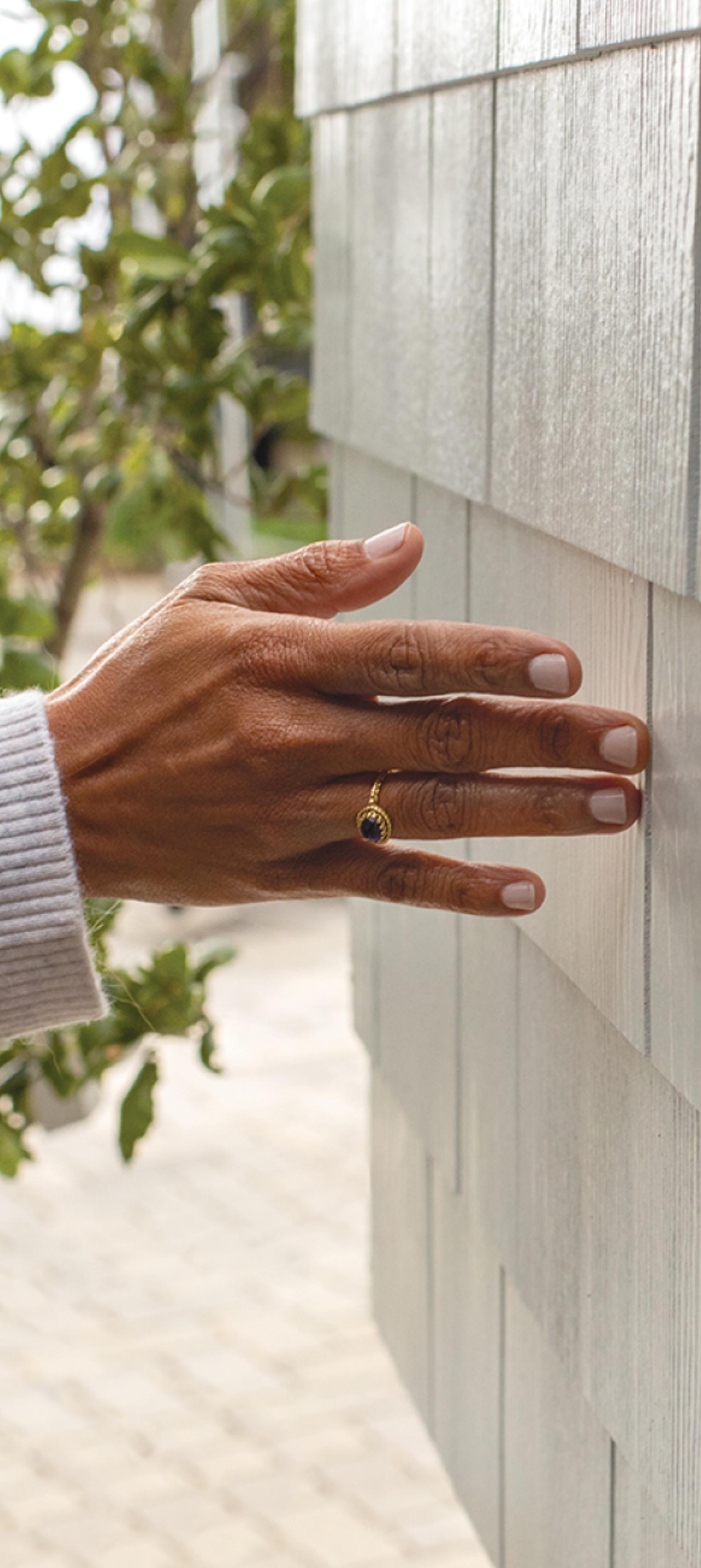 closeup of a hand on hardie shingle arctic white