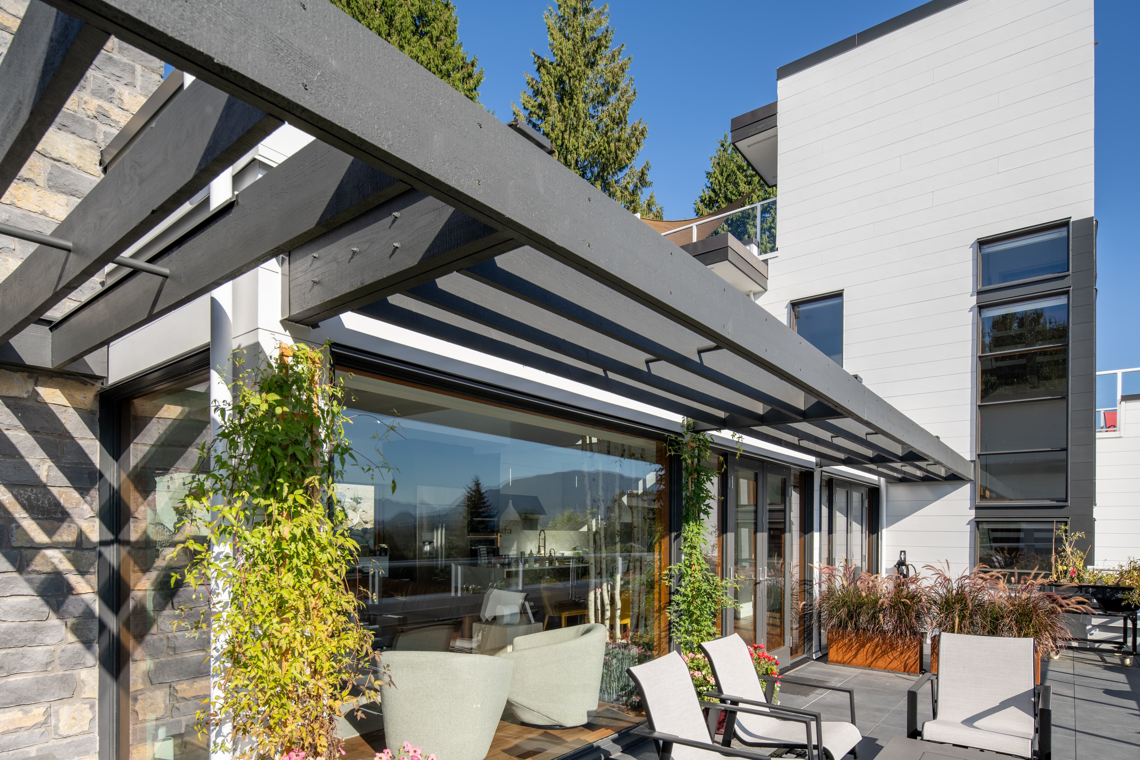 Contemporary - Rooftop deck featuring greenery and a glass sunroom. Building clad in Artisan lap siding. Rooftop deck featuring greenery and a glass sunroom. Building clad in Artisan lap siding.