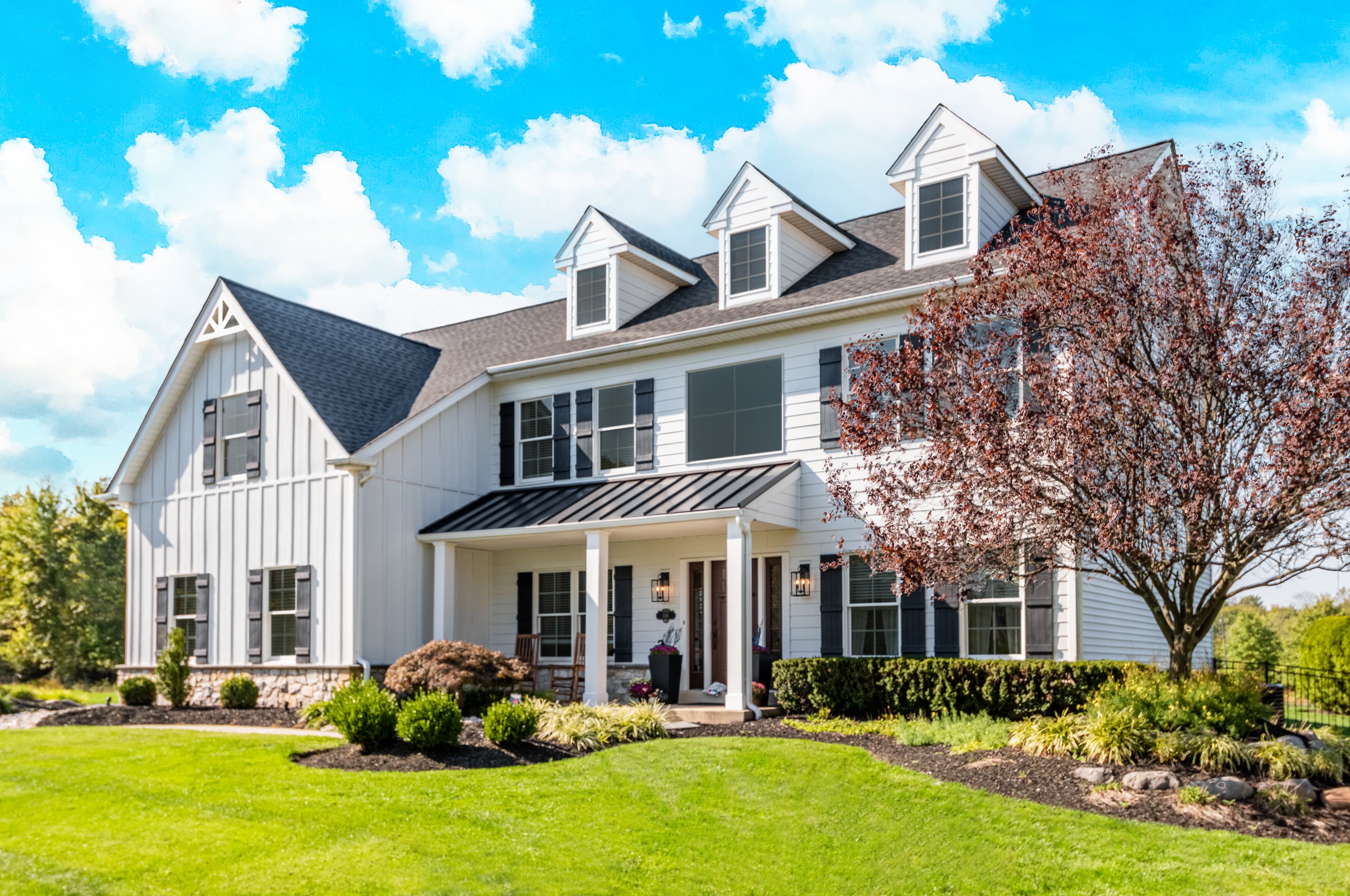 Cape Cod Style - A large, modern interpretation of the Cape Cod home in Arctic White batten boards A large, modern interpretation of the Cape Cod home in Arctic White batten boards