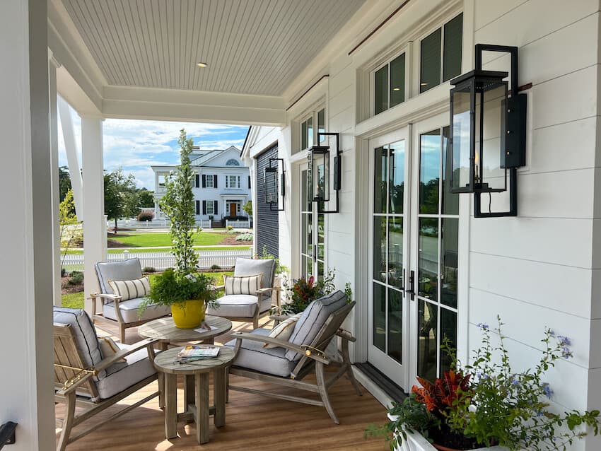 Enhancing Your Home's Exterior: Detail of a porch with large, wrought iron statement sconces. House clad in Hardie® Artisan Shiplap siding. Detail of a porch with large, wrought iron statement sconces. House clad in Hardie® Artisan Shiplap siding.