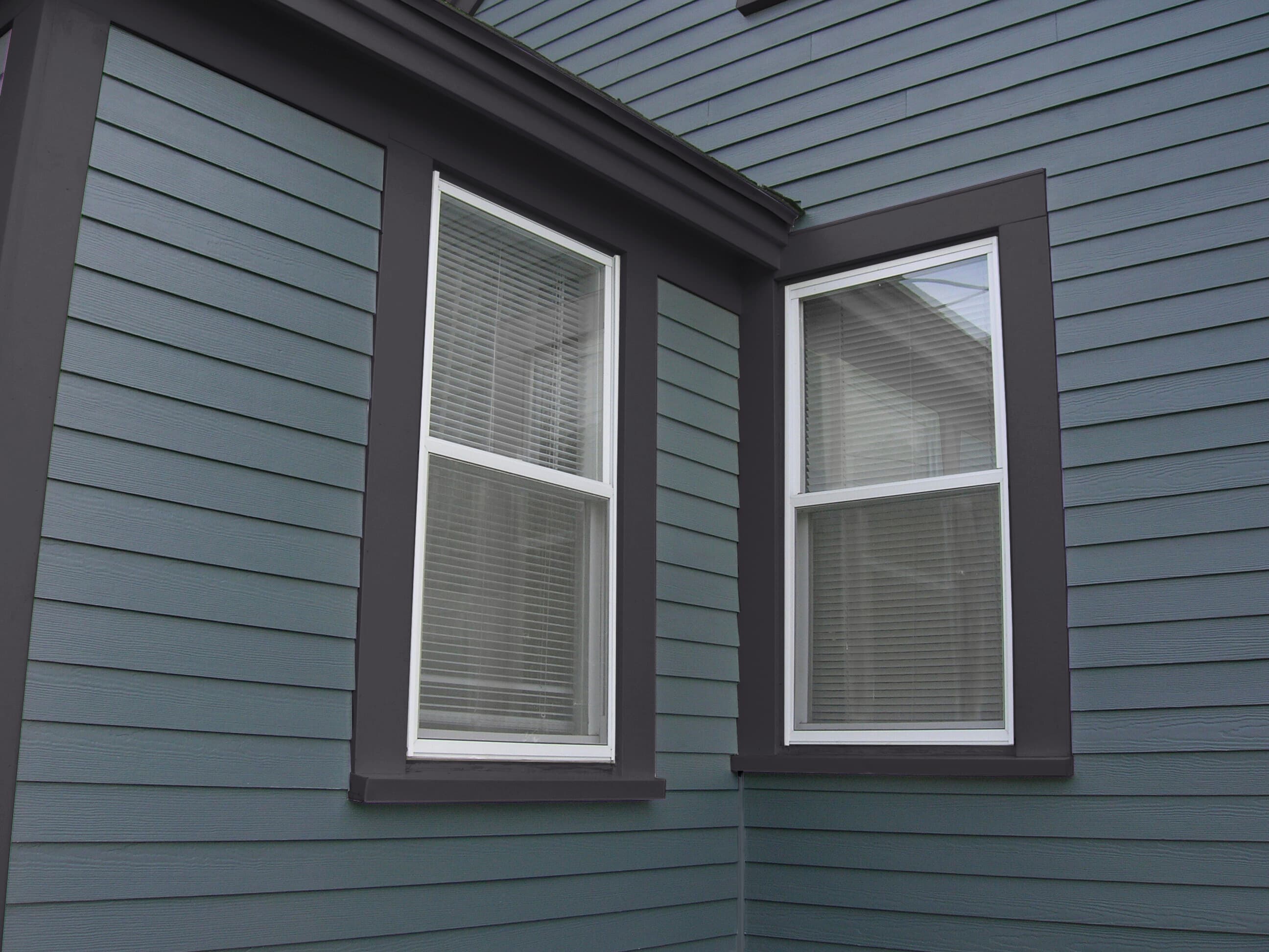 Cape Cod Style - A close up detail of blue Hardie Plank lap with dark blue Hardie Trim A close up detail of blue Hardie Plank lap with dark blue Hardie Trim